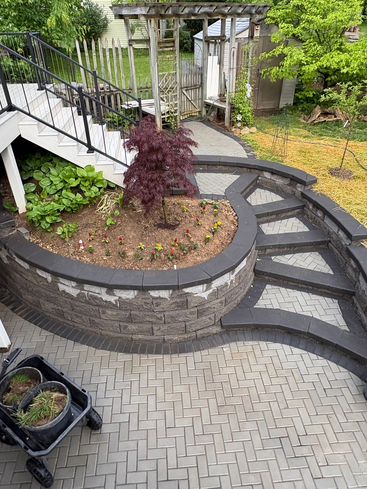 Tiered stone wall with paved steps and garden bed